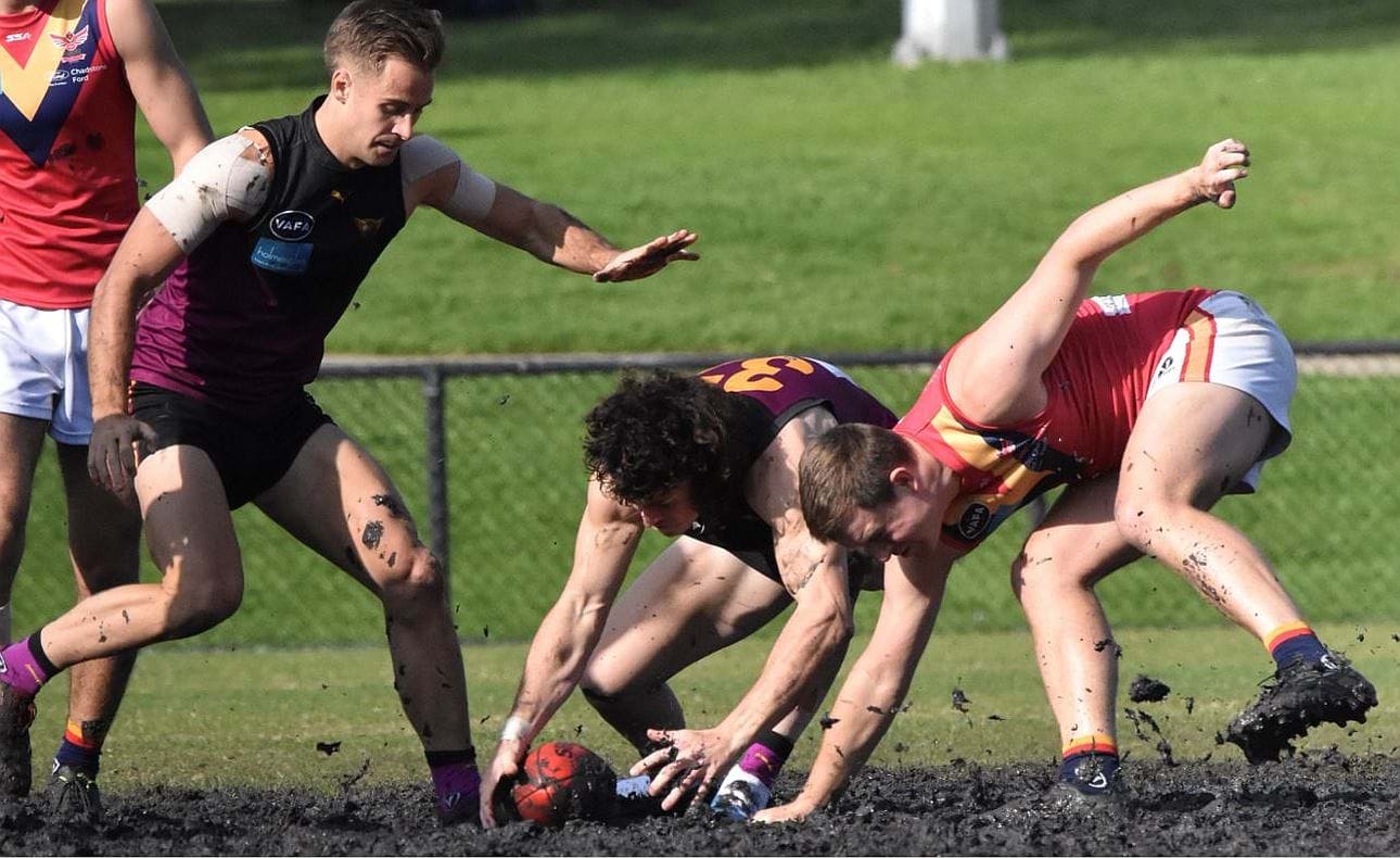 Luke Bailey gets down and dirty in the Princes Park centre gluepot, supported by Brodie Steele
