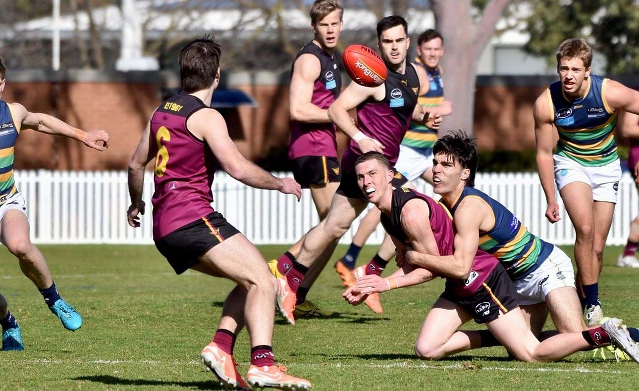 James Connell just gets a handball out to acting captain Josh Gasparini