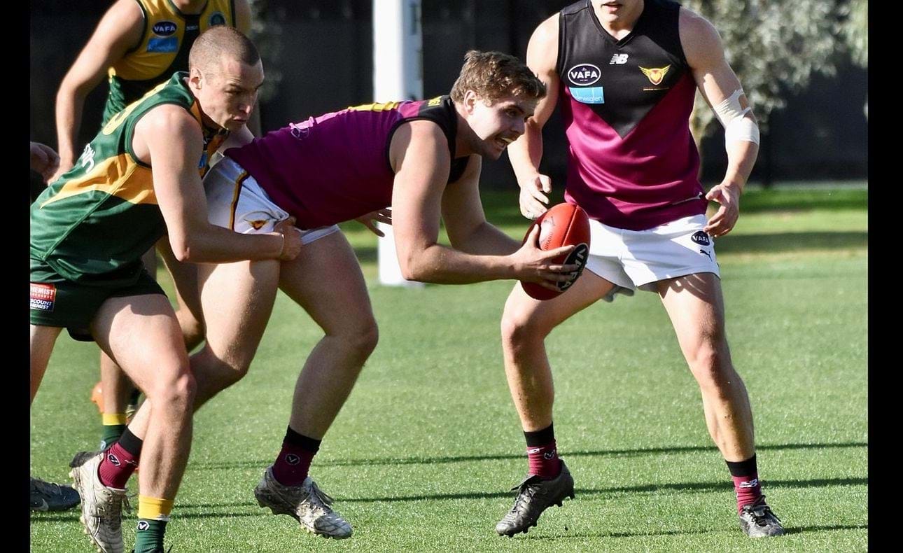 Liam Wood caught up in a Trinity tackle