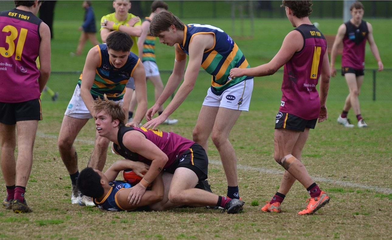 Wes Sando all over his St Kevin's opponent; James Waters (31) and Luke Jamieson (11) look on