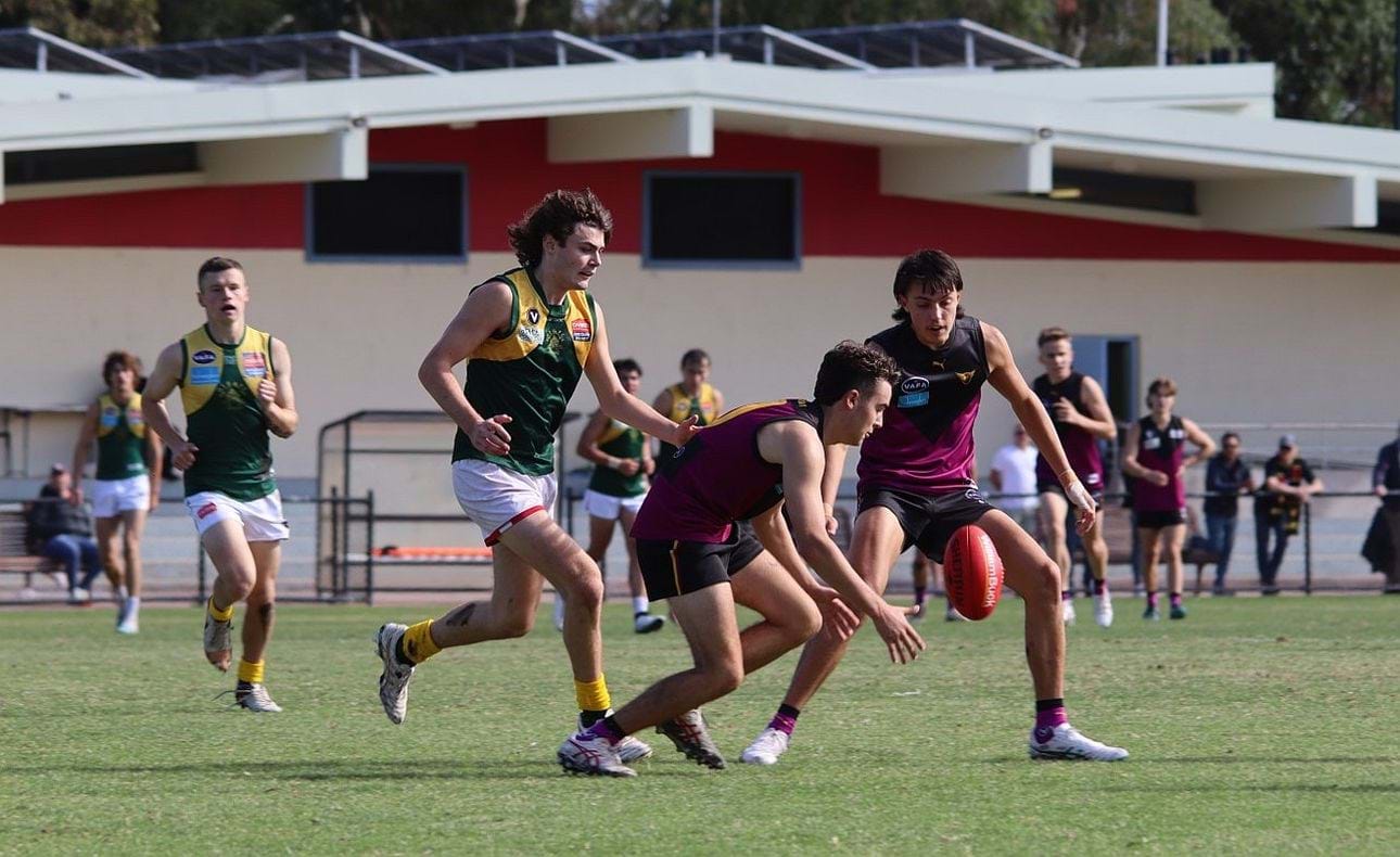 Liam Riedel collects the ball in front of Jack Kennedy
