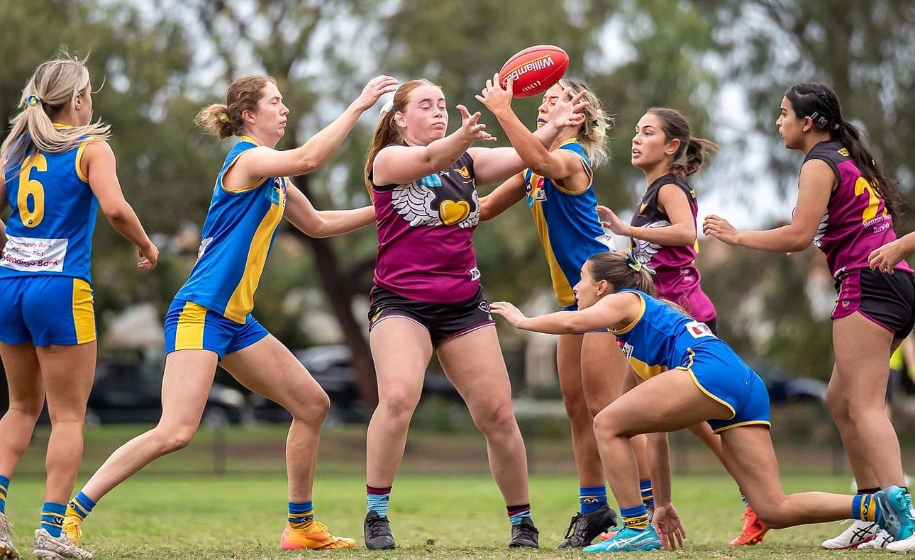 Amy Montebelli battles for the ball backed up by Jasmine Bettess and Marissa Van Heer