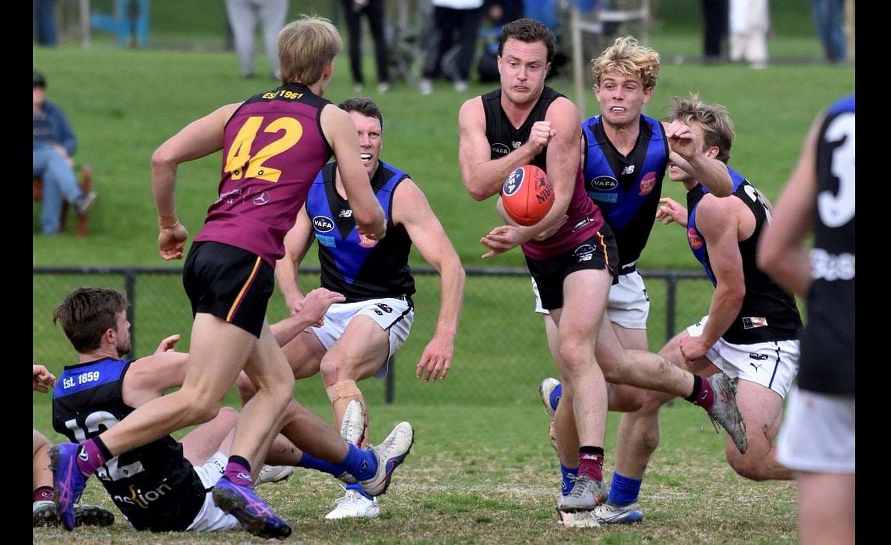 Max Sievers shoots a handball out to Charlie Harrop (42)