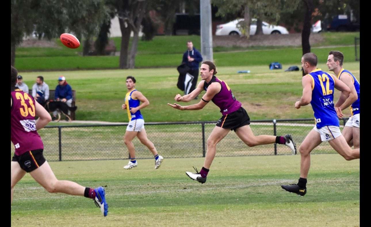 Will Paul clears out of defence with a long handball