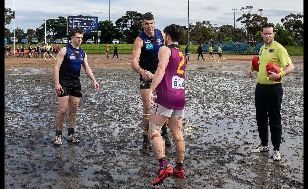 Captain James Paul is pristine for the coin toss in the middle of the Elsternwick Park slop - but not for long