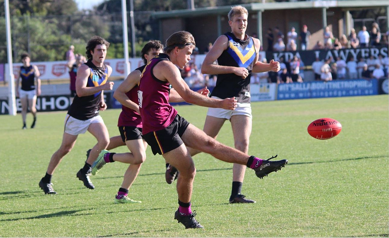 Will Abraham clears in the Under-19s Grand Final against Old Carey at Trevor Barker Oval