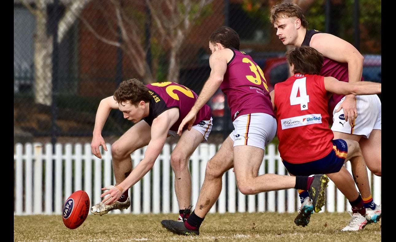 Lucas Hornblower stoops to gather with Will Barrie (39) and Keegan Mountford nearby