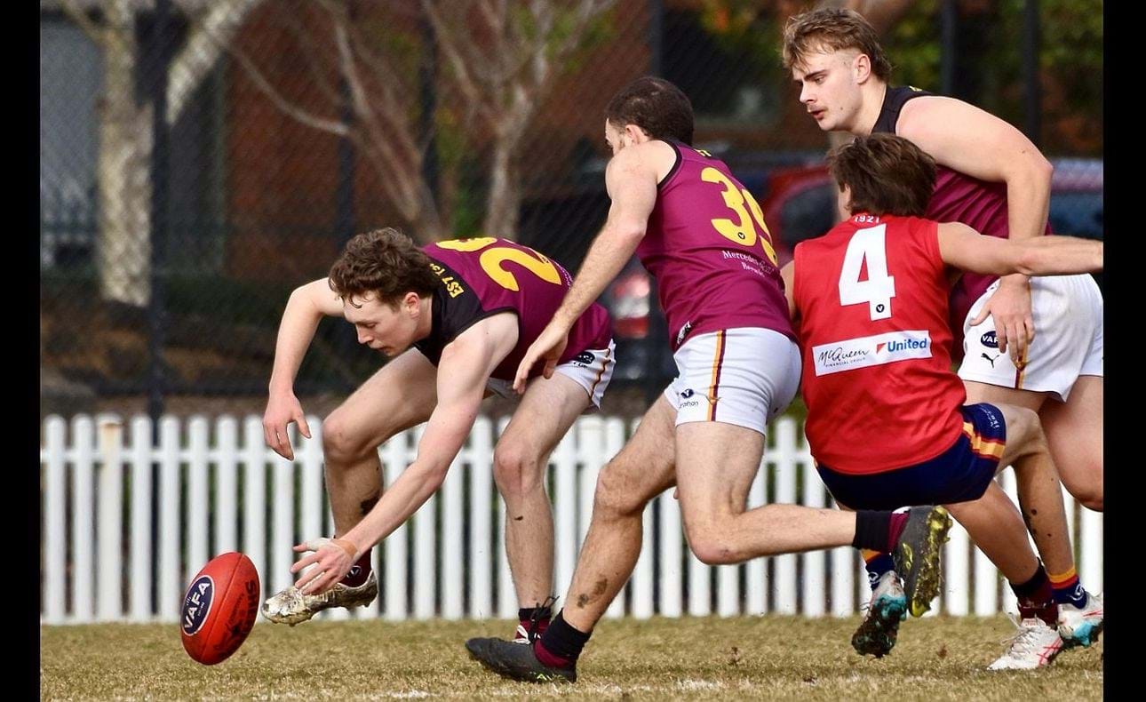 Lucas Hornblower stoops to gather with Will Barrie (39) and Keegan Mountford nearby