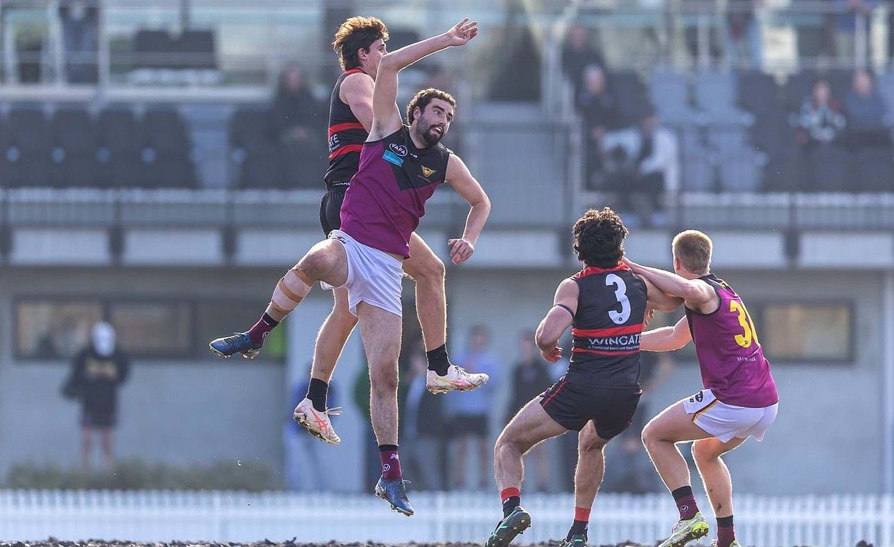 Jack Bell in an early centre bounce with Lachlan Giliam (36) in support
