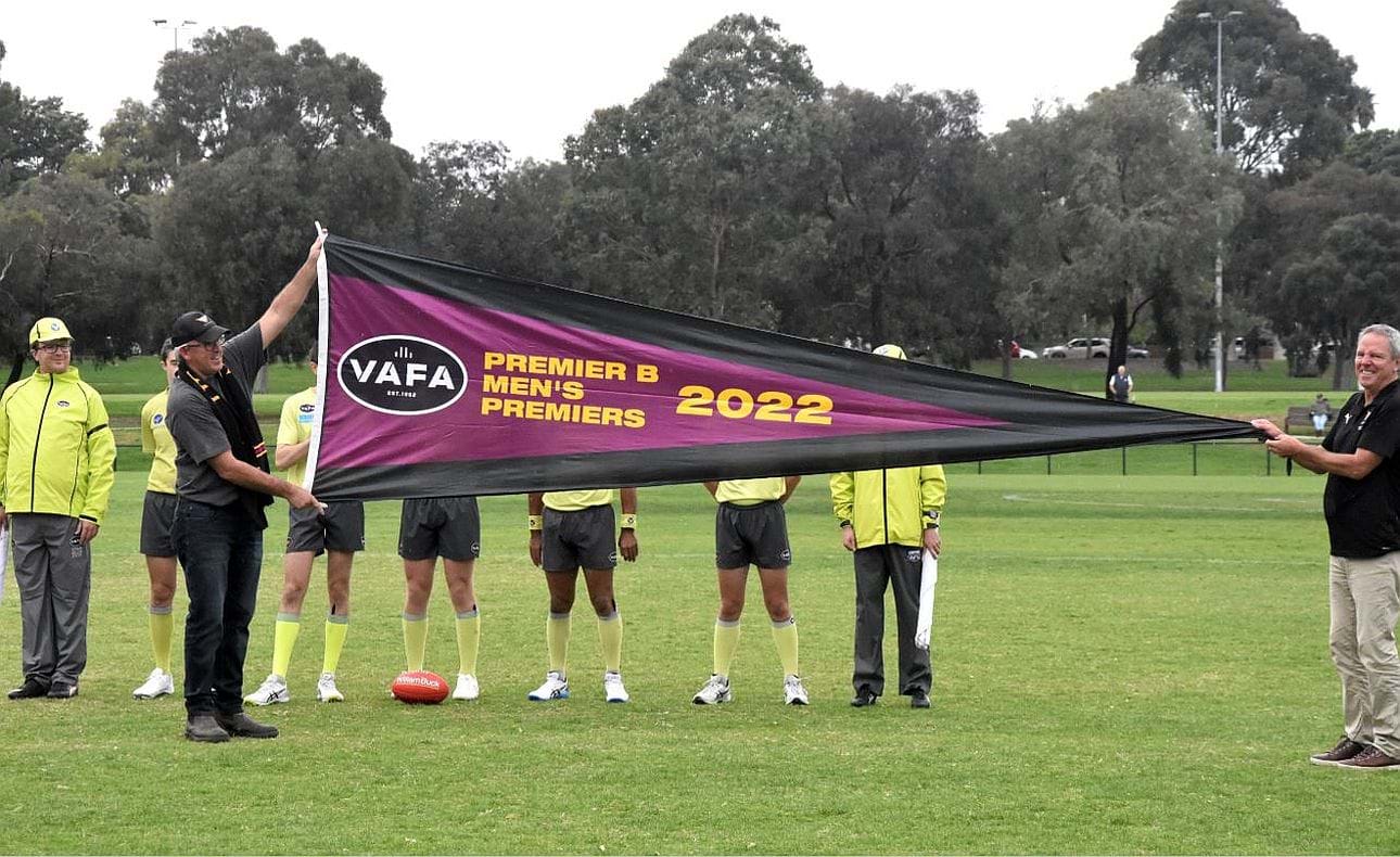 Premiership president Mick Constable and club legend Andrew Hicks unfurl the 2022 B Grade premiership flag before the opening round match against St Kevin's Old Boys.  The Bloods battled bravely to give the reigning A Grade premier a huge scare, going down only by a solitary point.