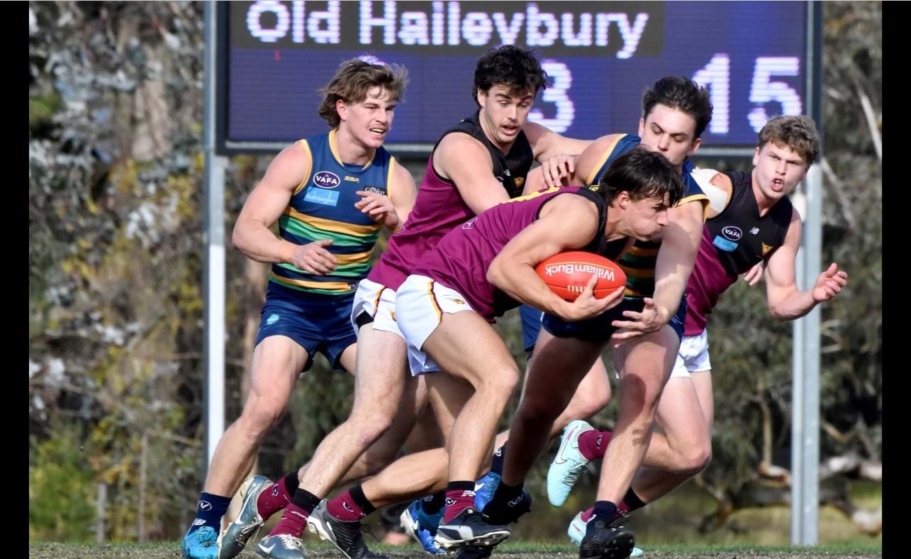 Lachie Riley wins yet another centre clearance with Lachie Vaughan and Hugo Nosiara in support