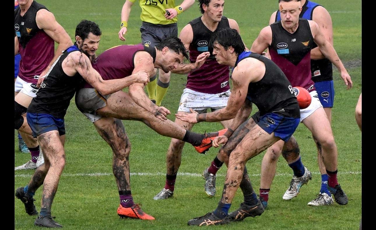 Captain Brede Seccull shows the importance of getting boot to ball in the sloppy conditions
