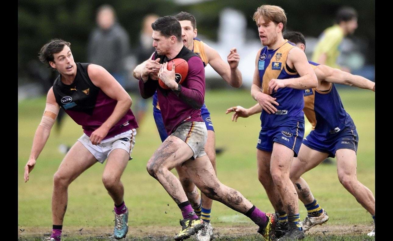 Brede Seccull bullocks his way through the pack, Lachie Vaughan ready to shepherd
