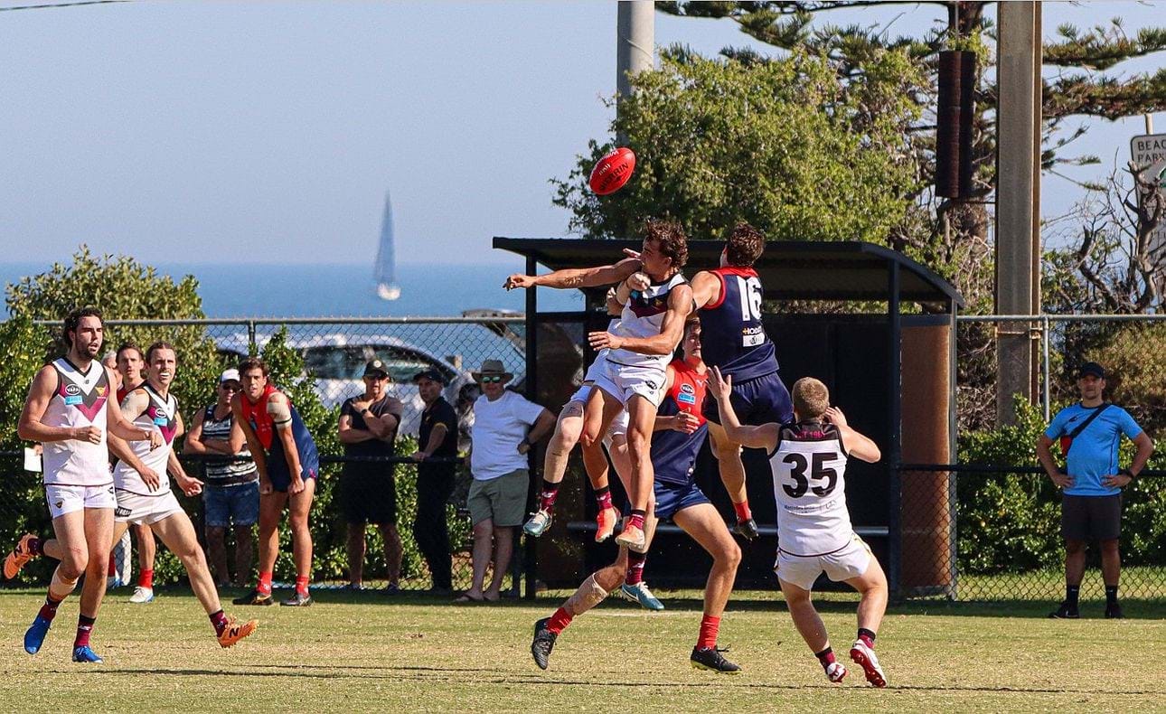 Conditions were near perfect in the sun at Brighton Beach with the bay in the background; here Ned Conway rises in the pack with backup from Jack Bell, Will Paul and Liam Kirkwood-Scott (35)