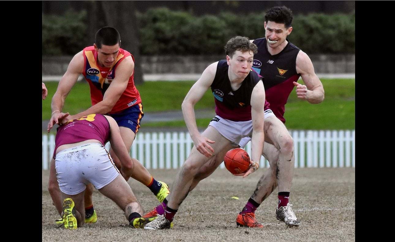 Lucas Hornblower prepares to handball in front of Brede Seccull