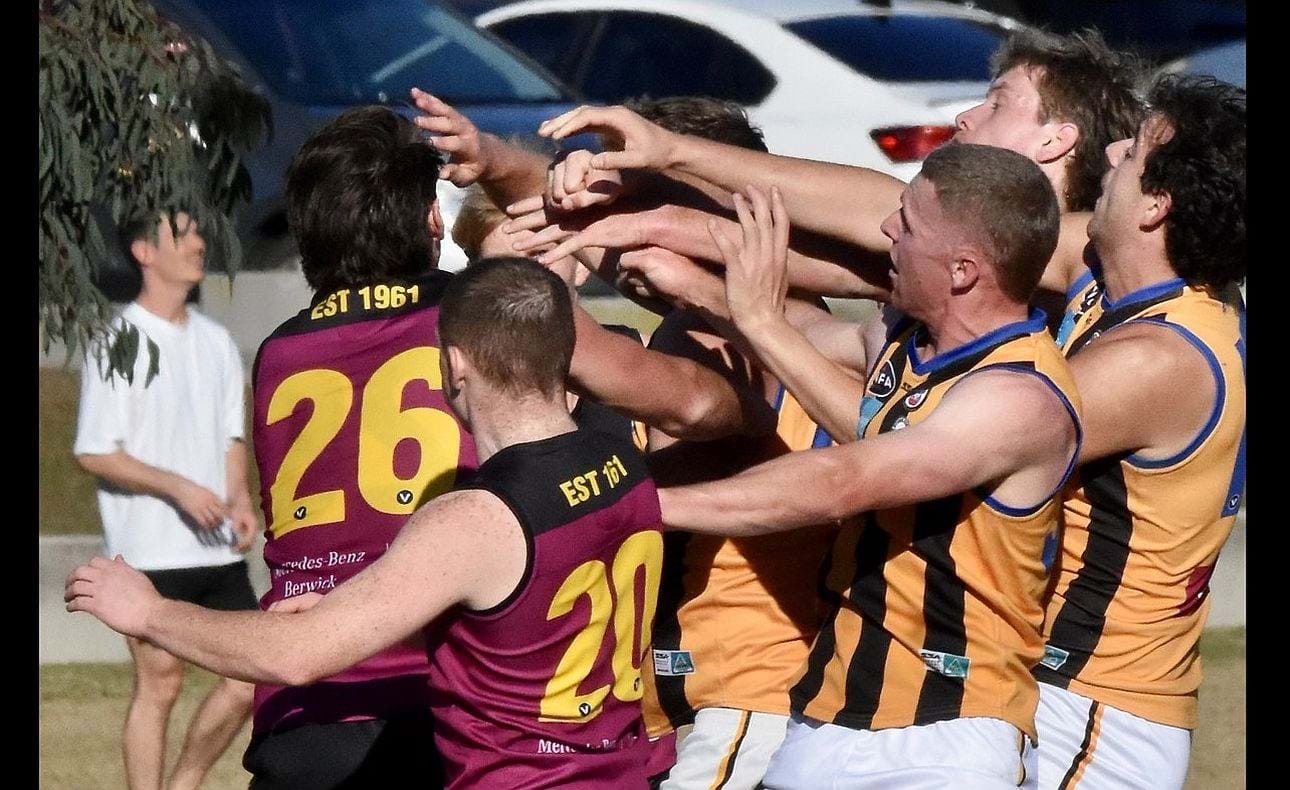 Forwards Harrison Jones (26) and Dre Stefanakis (20) join the tangle of arms