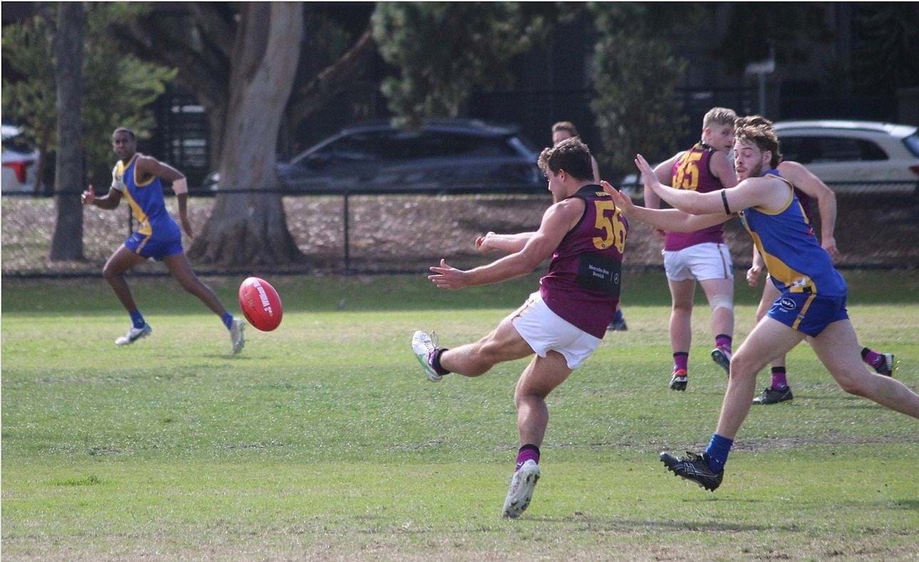 Billy Mackay (56) kicks forward on his trusty left foot