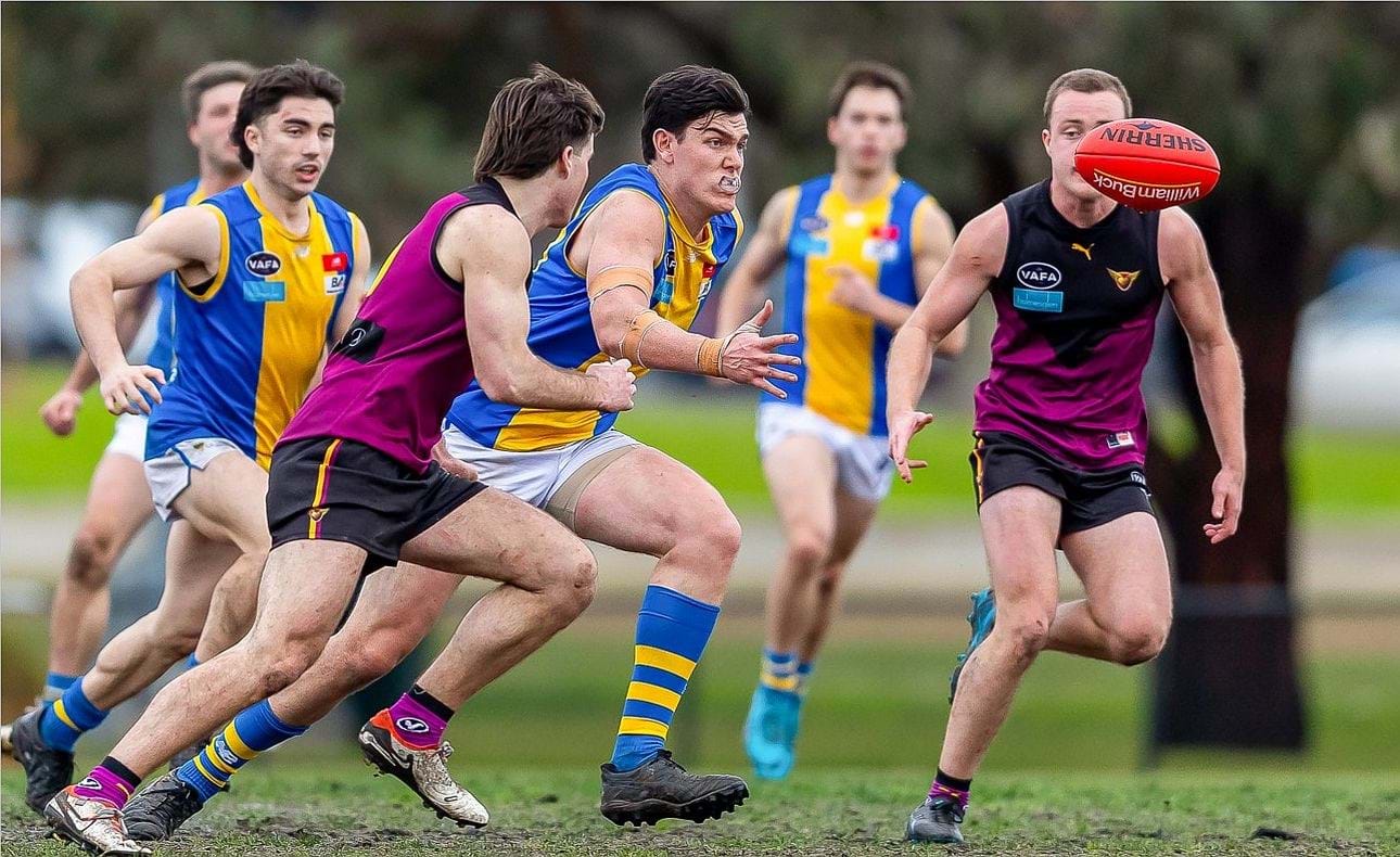 Josh Gasparini in pursuit in his 100th game, Max Sievers nearby