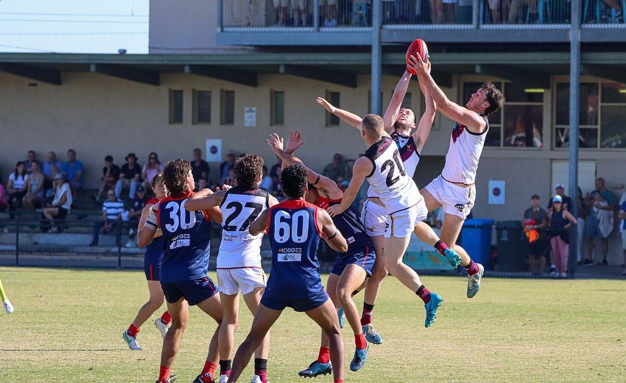 Lachie Vaughan and Durras Seccull share a mark, Olli Hotton (27) and Dre Stefanakis (20) in the foreground