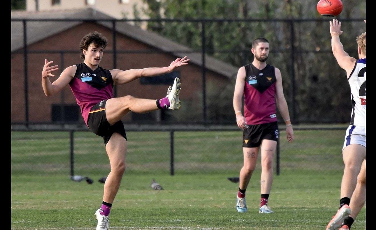 Olli Hotton kicks late in the game, Durras Seccull watches on