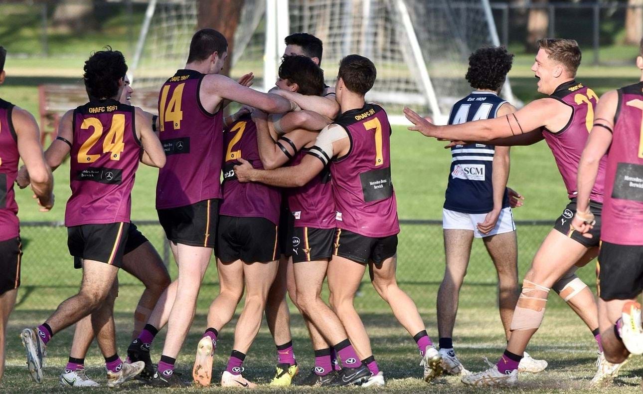 Team mates gather round James Paul to celebrate a goal to top off his milestone game