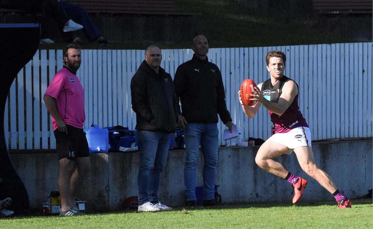 Skipper James Paul in front of runner Brock McLean, coach Daniel Ward and assistant Stewart Loewe