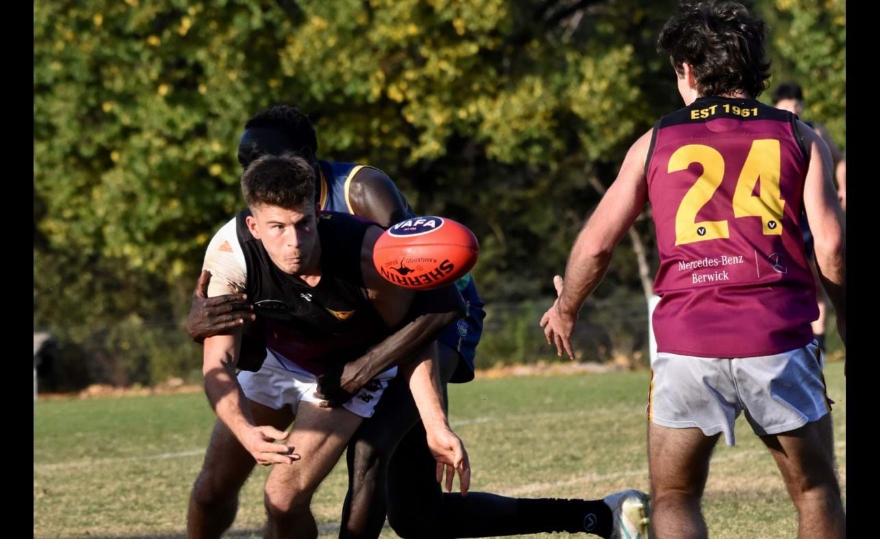 Connor Riley's eyes on the ball, Charlie Sinclair (24) about to receive