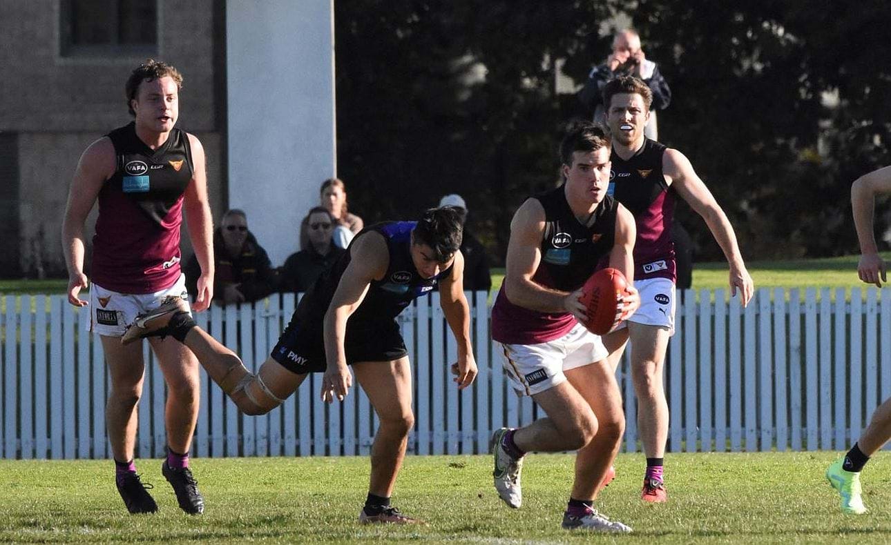 Josh Gasparini with another clearance ahead of team mates Max Sievers and James Paul