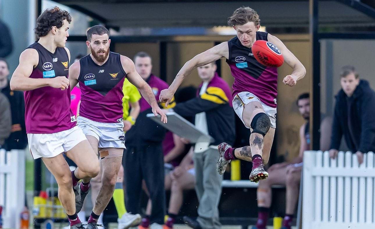 Rayner Seccull kicks clear with Josh Gillon and Will Barrie in support