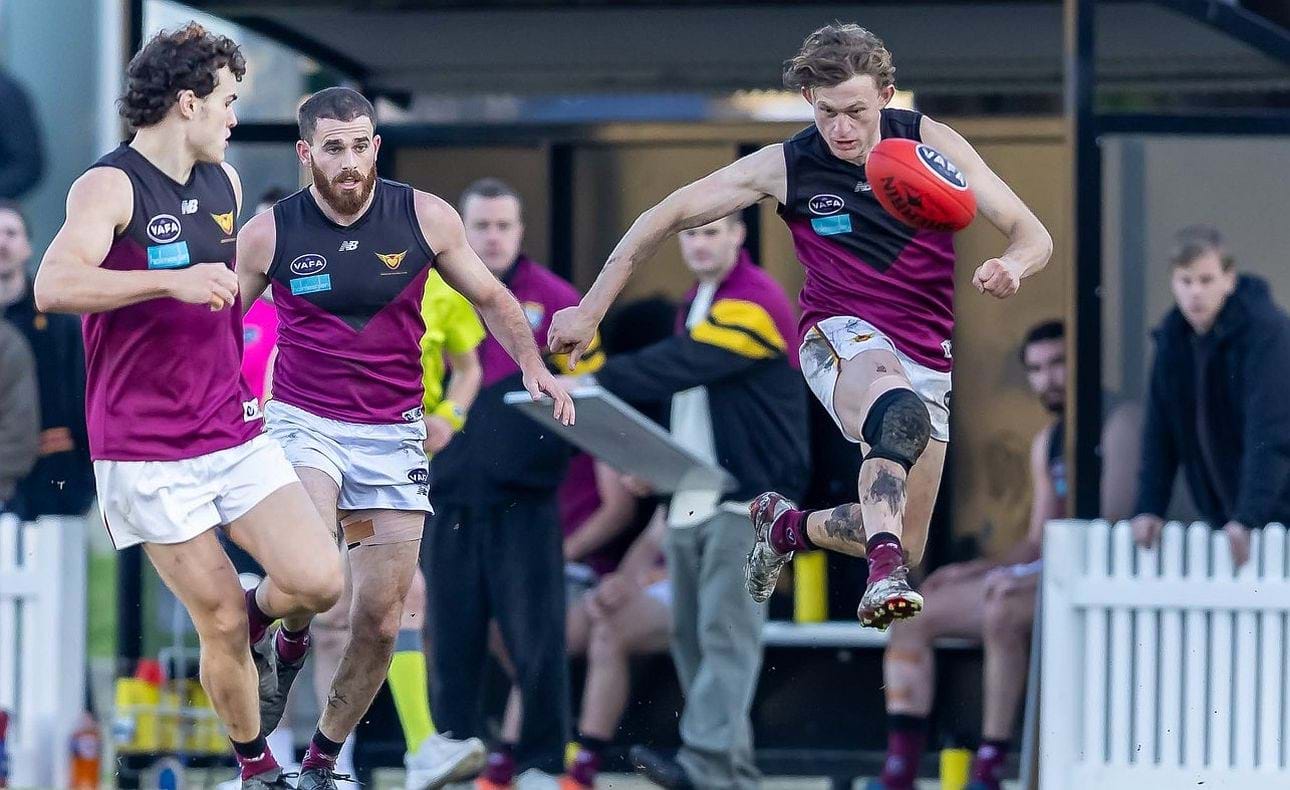 Rayner Seccull kicks clear with Josh Gillon and Will Barrie in support