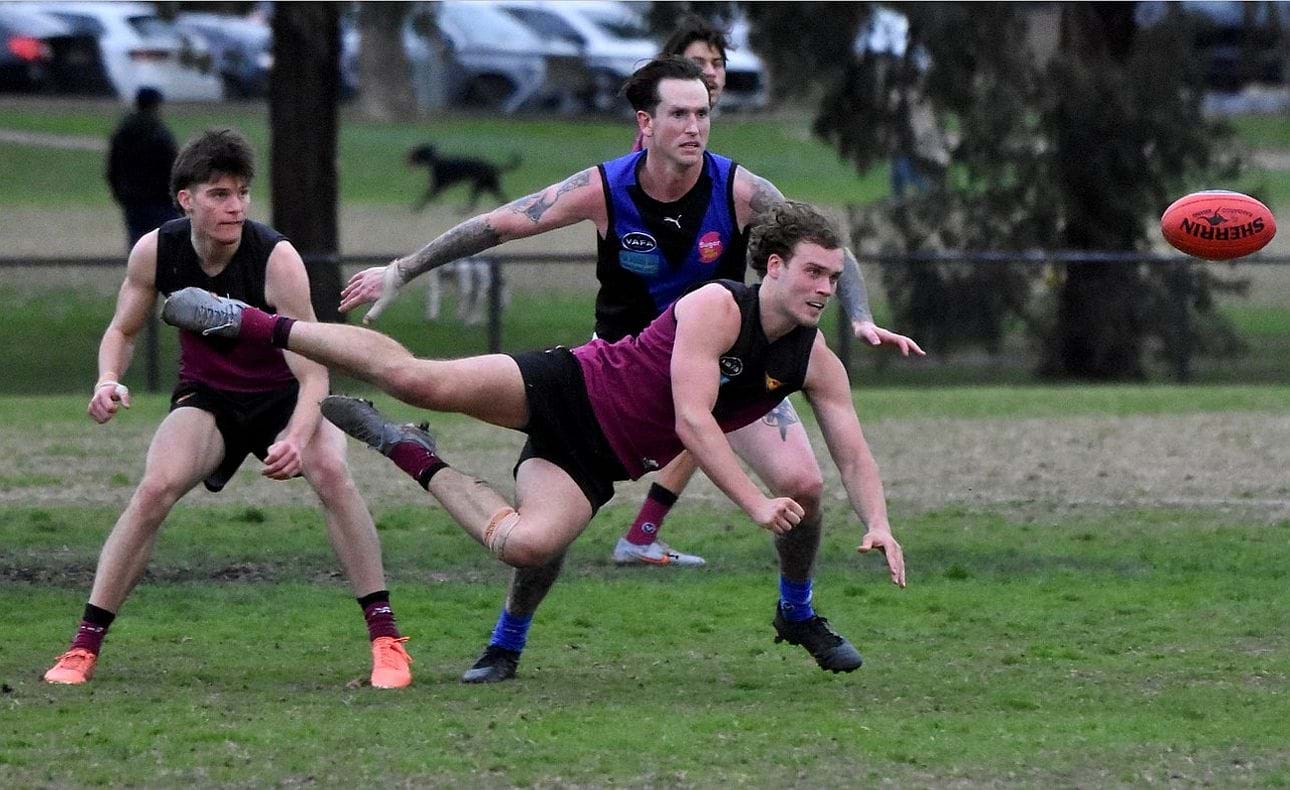 A flying Joel Chilcott with James Blight looking on