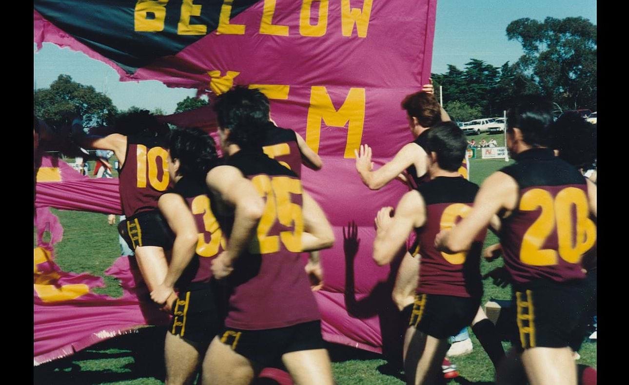 Players bursting through are Tim Chegwin (10), Matthew Armstrong (36), Matt Colston (25), Fraser Main (5), John Bingham, Wayne Smith (6) and coach Simon Meehan (20)