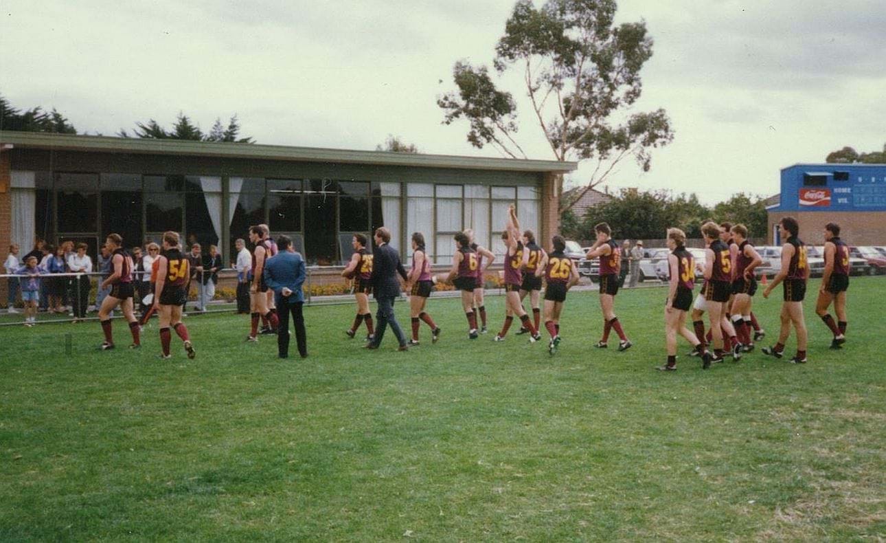 Players line up with Ken Allison for the flag unfurling