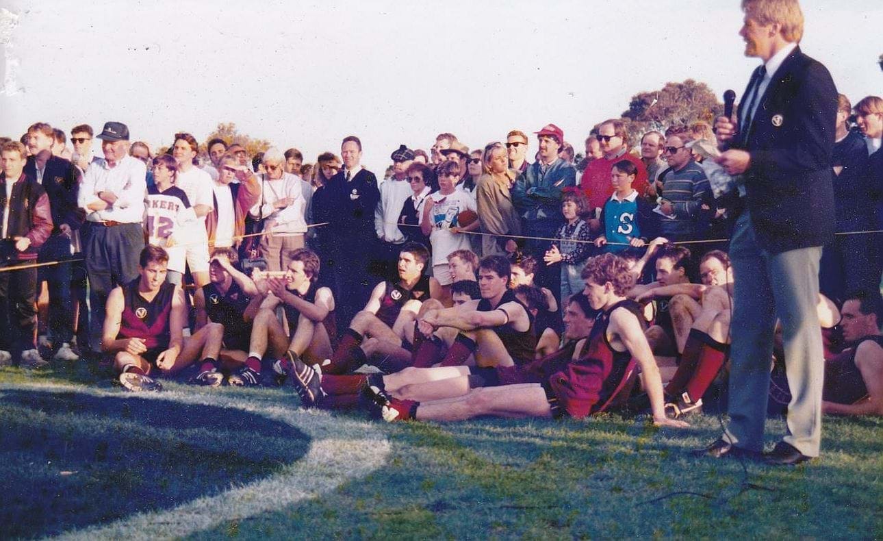 Players await the presentations with former coach Phil Stevens, now VAFA General Manager at right