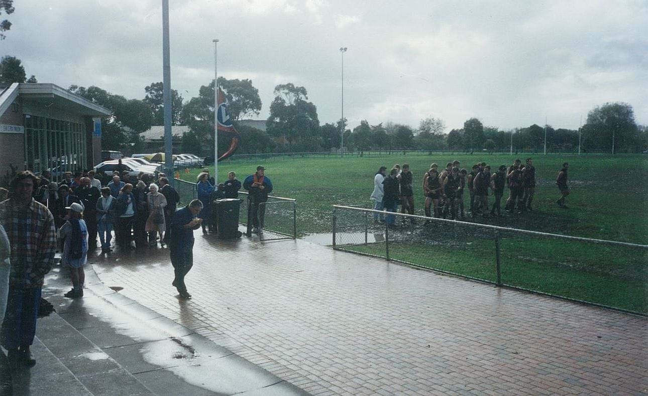 Glum surroundings at McKinnon for Mark Orton's 150th game.  President Ken Phillips had passed away the previous weekend and McKinnon turned on rain and a quagmire.  The reserves line up to await the senior team.