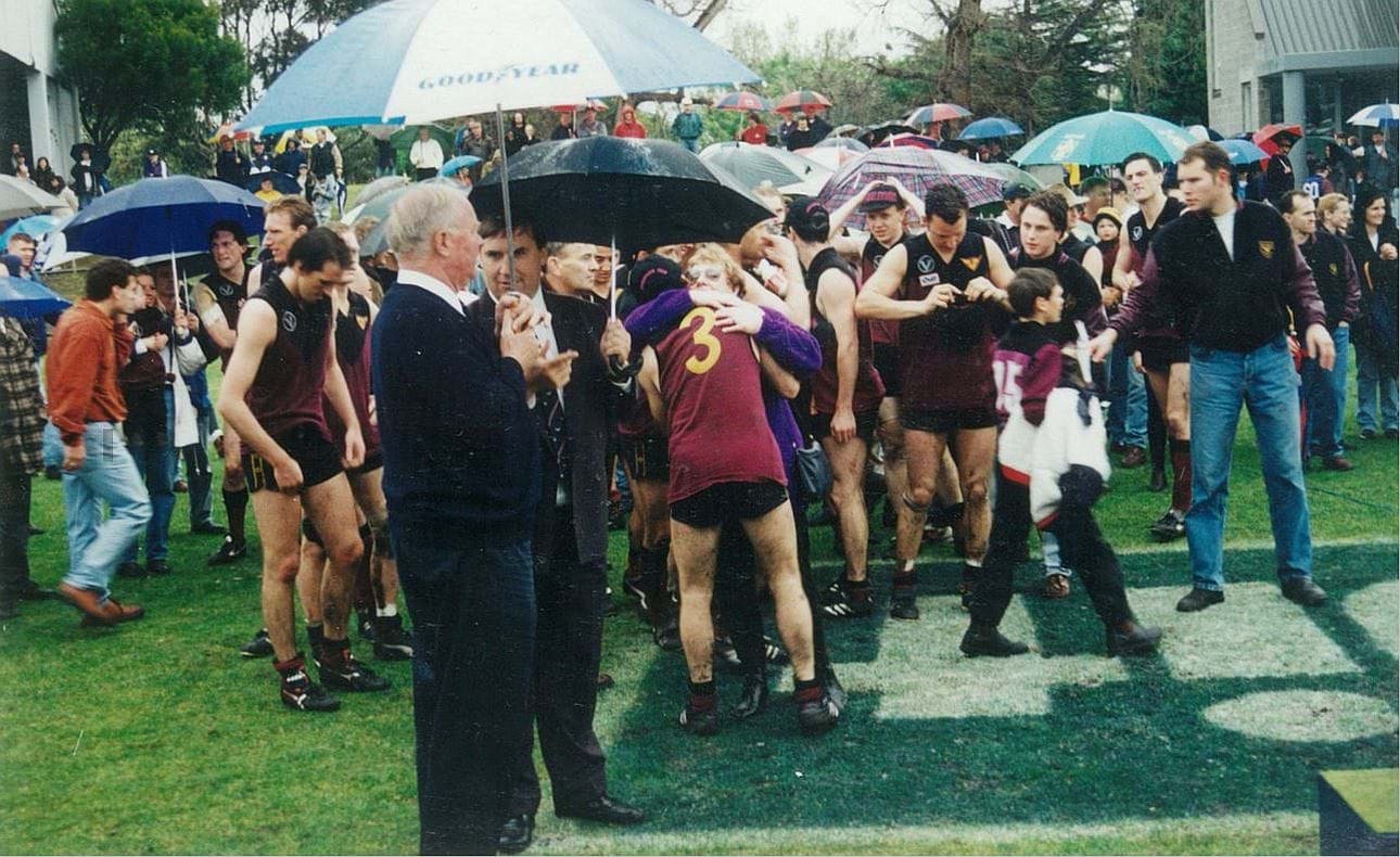 Former OHAFC coaches Max Lyon and Andrew Langford-Jones in the foreground, Wes Byrns (3) in embrace behind