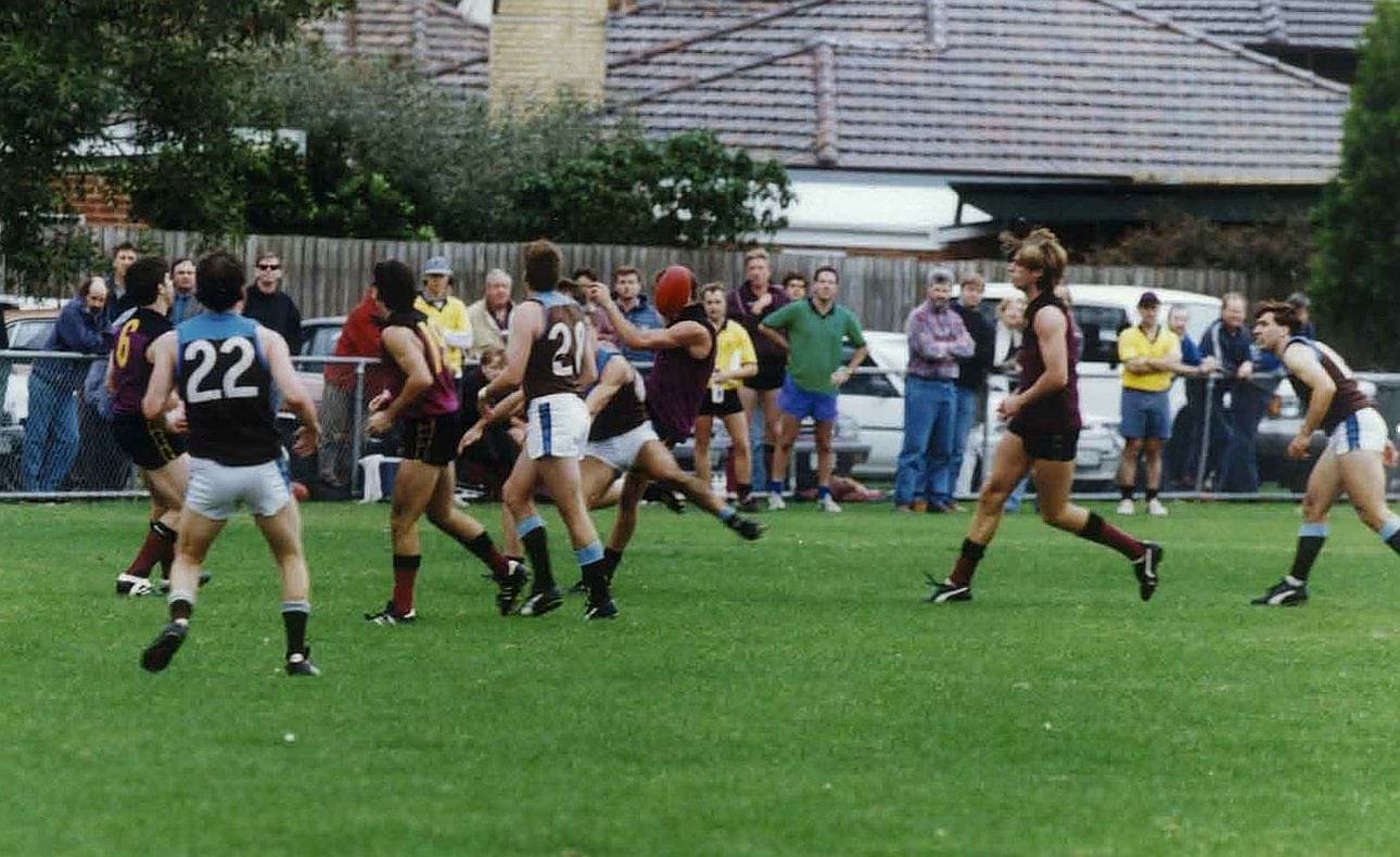 Impossible to tell who is kicking the ball but Wayne Smith (6), Matthew Armstrong (19) and Adam Hilton are nearby