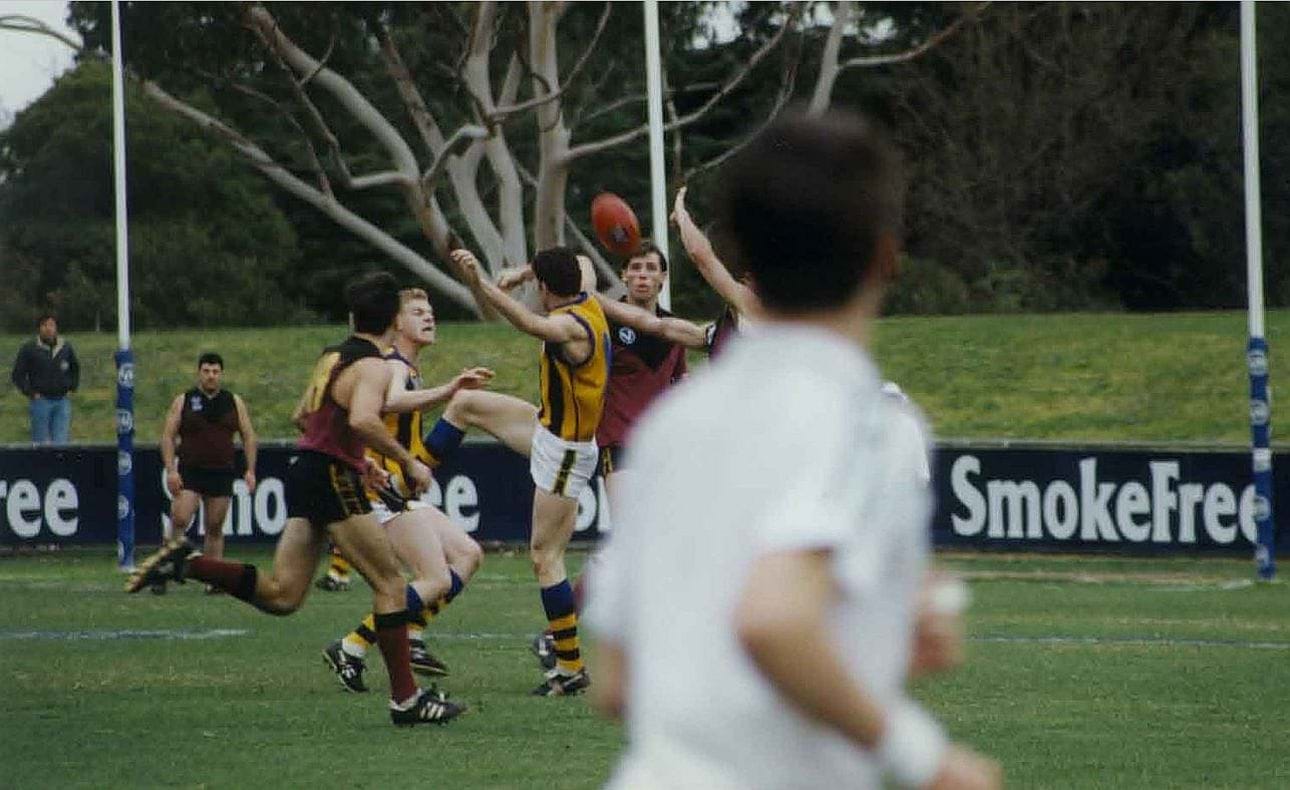 Matthew Armstrong (19) and Adam Hilton watch the contest while back in the goal square looms the imposing figure of Chris Efstathiou