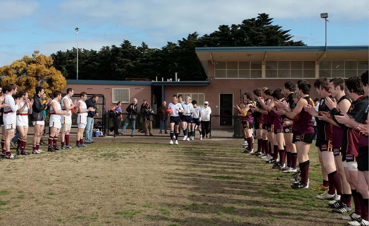 A guard of honour for milestone umpire Wayne Hinton in the Round 17 match against Marcellin Old Collegians at McKinnon