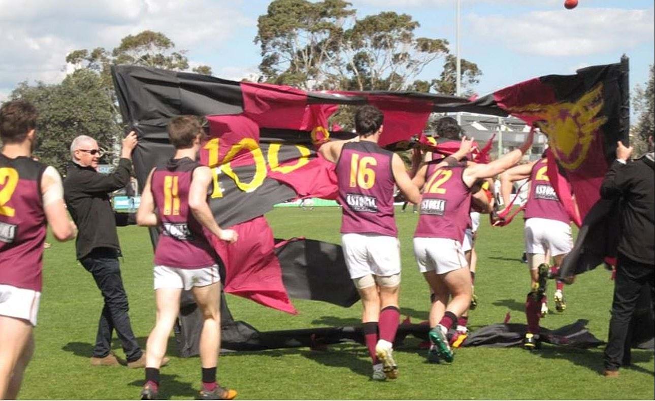 Grand Final Day 2015 at the Trevor Barker Oval, Sandringham; breaking the banner are James Paul (2), Jordan Donnelly (11), Nick Harrison (16) and Josh Dawson (12)