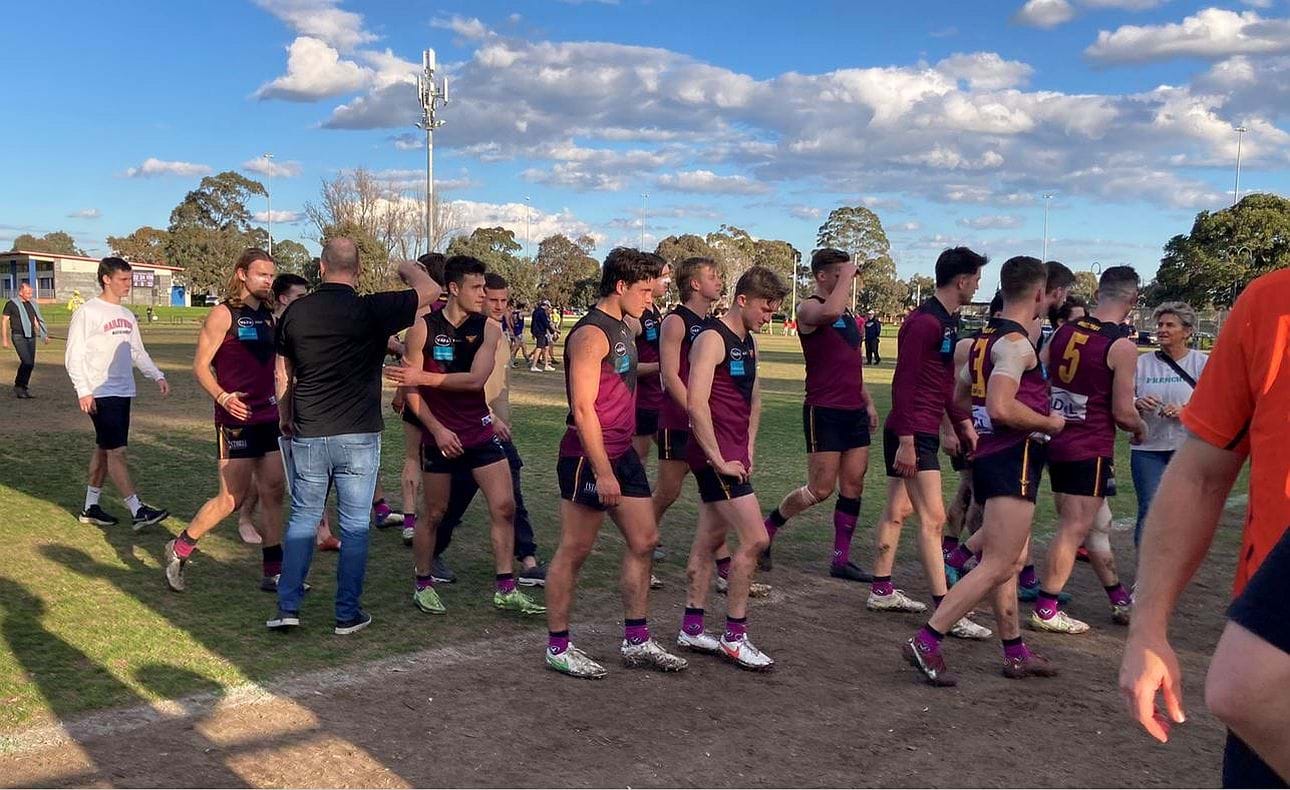 Happy coach Daniel Ward shepherds his team off the ground after their last home and away match and a comprehensive win over Williamstown CYMS as finals await