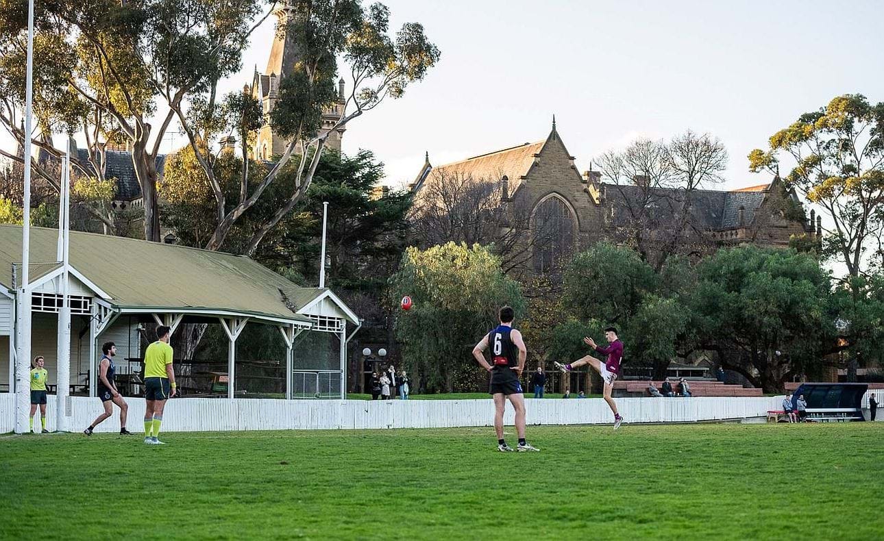 Noah Gown shoots for goal in the shadow of the old pavilion at  University Oval