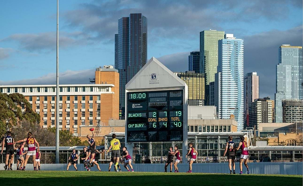 The scene at University Oval with the Raymond Priestley building and those of the city in the background, and the Bloods off to an early lead